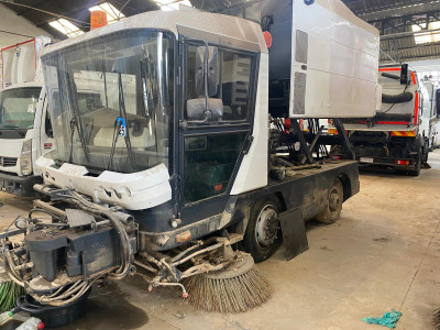 Tall slender porcelain bottle with natural clay textured body and cork stopper.