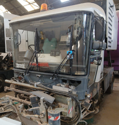 Tall slender porcelain bottle with natural clay textured body and cork stopper.